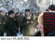Maykop, Russia - January 13, 2024: parents and relatives stand on the parade ground in front of rows of young soldiers during the taking of the military oath by recruits on a winter morning. Редакционное фото, фотограф Андрей С / Фотобанк Лори