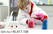 a student in a chemical laboratory conducts chemical sweats with chemical elements. Стоковое фото, фотограф Igor Skripachev / Фотобанк Лори