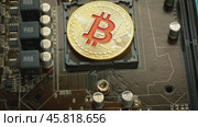 Gold Bit Coin BTC coins on the motherboard. Bitcoin is a worldwide cryptocurrency and digital payment system called the first decentralized digital currency. Стоковое видео, видеограф Андрей Армягов / Фотобанк Лори