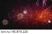 Colorful fireworks exploding in the night sky. Celebrations and events in bright colors. Стоковое видео, видеограф Андрей Армягов / Фотобанк Лори