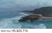 Flying over beautiful sandy beach and rocks with cloudy sky. Стоковое видео, видеограф Михаил Коханчиков / Фотобанк Лори