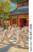 Young monks practicing kung fu in traditional temple courtyard. Стоковое AI-изображение, AI-художник Юрий Поздников / Фотобанк Лори