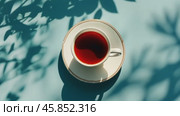 Elegant Tea Cup Set Against a Blue Background. Top view, flat lay. Copy Space. Relaxation and Enjoyment. Crafted Porcelain Teacup and Saucer on a soft pastel surface, lifestyle themes. Cup of warm tea. Стоковое AI-видео, аниматор Марина Демидюк / Фотобанк Лори