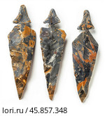 Three obsidian arrowheads pointing upwards on white background. Стоковое AI-изображение, AI-художник Иван Рябоконь / Фотобанк Лори