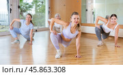 Dynamic women doing stretching in training hall. Стоковое фото, фотограф Яков Филимонов / Фотобанк Лори