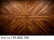 Polished wooden floor showing an intricate herringbone pattern design. Стоковое AI-изображение, AI-художник Иван Рябоконь / Фотобанк Лори