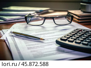 Accountant reviewing financial documents with calculator and eyeglasses. Стоковое AI-изображение, AI-художник Иван Рябоконь / Фотобанк Лори