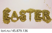 Golden glitter easter text dissolving on pink background. Стоковое AI-видео, аниматор Юрий Поздников / Фотобанк Лори