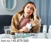 Woman with fever symptoms sitting at home. Стоковое фото, фотограф Яков Филимонов / Фотобанк Лори