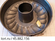 Greasing bundt pan with butter, baking preparation in kitchen. Стоковое фото, фотограф Андрей Знаменский / Фотобанк Лори