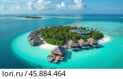 Hotel from a group of bungalows on the water on a caral island in a delightful turquoise lagoon. Copy space. AI generative. Стоковое AI-изображение, AI-художник Роман Дзюбало / Фотобанк Лори