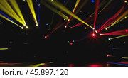 a multitude of multi-colored stage lights with narrow colored beams of light on a dark stage background. Стоковое AI-видео, аниматор Александр Довянский / Фотобанк Лори