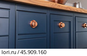 Front kitchen wooden frame cabinet door and drawers. Closeup Dark Blue Kitchen. Wooden cabinet door, brass door handles, furniture base set. Trendy interior units. Home improvement concept. Samples. Стоковое AI-видео, аниматор Марина Демидюк / Фотобанк Лори