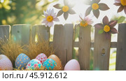 Easter eggs set against a natural hay background symbolize the joy and renewal of the Easter season. in straw on a hayloft, festive decor background. Holiday, Easter traditions, travel. Стоковое AI-видео, аниматор ALLA YURTAYEVA / Фотобанк Лори
