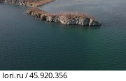 Drone flight around the rocky shore of Cape Shamansky and Lake Baikal on a sunny day in late autumn. breathtaking panorama of Lake Baikal. aerial view. Стоковое видео, видеограф ЛУНИНА ВЕРОНИКА / Фотобанк Лори