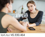 Sad woman sits silently in kitchen, friend sympathize and comfort her. Стоковое фото, фотограф Яков Филимонов / Фотобанк Лори