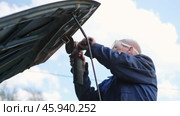 Car body shop. Repair man processes the welding seam using an angle grinder on replaced car part. Professional Body master grind old paint and rust. Rusty damage. Rusting car. Hands with tool close-up. Стоковое видео, видеограф Марина Демидюк / Фотобанк Лори