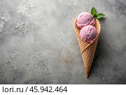 Sweet dessert. Ice cream cones with different flavors on a concrete gray background. World Ice Cream Day. Стоковое AI-изображение, AI-художник Photojuli / Фотобанк Лори