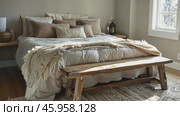 Rustic home design with ethnic boho decoration. Bed with pillows, wooden furniture. Bohemian bedroom with cream-colored textiles, dried flowers. Serene, cozy ambiance. Scandinavian natural interior. Стоковое AI-видео, аниматор Марина Демидюк / Фотобанк Лори