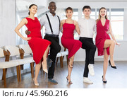 Smiling young multinational men and women dancing catalan typical Sardanas in dance salon. Стоковое фото, фотограф Яков Филимонов / Фотобанк Лори