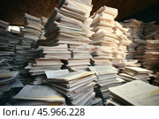 Stacks of paper showing bureaucracy, messy administration, and inefficiency. Стоковое AI-изображение, AI-художник Иван Рябоконь / Фотобанк Лори