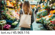 Walking through a lively market filled with fresh organic vegetables, girl carrying her eco-friendly cotton backpack. Mock up bag, copy space. Стоковое AI-изображение, AI-художник Юлия Ильина / Фотобанк Лори