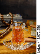 Azerbaijani black tea in armudu tea glass. Atmosphere of Baku and Eastern traditions. Oriental cuisine. Cozy atmosphere in the caucasus cafe. Стоковое фото, фотограф Андрис Салминьш / Фотобанк Лори