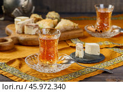 Azerbaijani black tea in armudu tea glass. Atmosphere of Baku and Eastern traditions. Oriental cuisine. Cozy atmosphere in the caucasus cafe. Стоковое фото, фотограф Андрис Салминьш / Фотобанк Лори