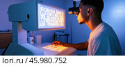 Patient undergoing eyesight exam with phoropter in ophthalmology clinic. Стоковое AI-изображение, AI-художник Юрий Поздников / Фотобанк Лори