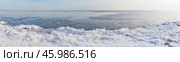 Panoramic view of freezing Baikal Lake on January day. Icy shore with ice floes on the beach during freeze-up. Lakeside landscape. Winter natural background. Changing seasons, environment. Стоковое фото, фотограф Виктория Катьянова / Фотобанк Лори