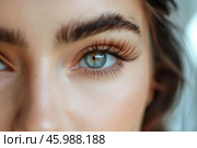 Woman showing long eyelashes and perfect eyebrows after beauty treatment. Стоковое AI-изображение, AI-художник Иван Рябоконь / Фотобанк Лори