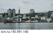 Cranes and shipyards dominate the foreground, while modern buildings rise in the background, creating a dynamic cityscape of vladivostok. Стоковое фото, фотограф Mikhail Davidovich / Фотобанк Лори