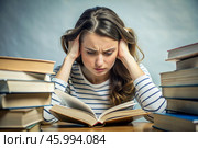 Reads, prepares for exams. use. Admission to the institute. A young girl holds her head among many books, stays at home and studies. Стоковое AI-изображение, AI-художник Photojuli / Фотобанк Лори