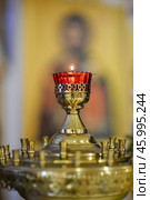 Lampada on a candlestick in an Orthodox church. Редакционное фото, фотограф Анна Никонорова / Фотобанк Лори