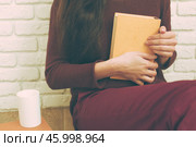 Pretty relaxed young woman reading a book. Стоковое фото, фотограф Сергей Толмачёв / Фотобанк Лори