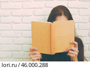 Pretty relaxed young woman reading a book. Стоковое фото, фотограф Сергей Толмачёв / Фотобанк Лори