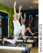 Mature woman actively doing Pilates exercises. Стоковое фото, фотограф Яков Филимонов / Фотобанк Лори
