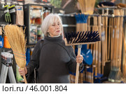 Mature woman choosing a broom. Стоковое фото, фотограф Яков Филимонов / Фотобанк Лори