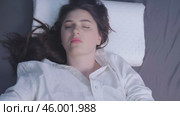 Comfortable sleep on soft pillows, woman peacefully resting on orthopedic pillows. Memory foam pillows improve circulation and prevent tissue compression. Стоковое видео, видеограф Svetlana Golovco / Фотобанк Лори