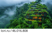 An impressive building, harmoniously integrated into the tropical forest. It has a stepped architecture with terraces on which numerous plants are located, including palm trees and other dense greenery, creating the effect of a vertical garden. The building is made of modern materials, its glass windows are illuminated by a warm yellow light, which creates a contrast with the cold green of the surrounding forest. The atmosphere is shrouded in fog, which adds mysticism and emphasizes the closeness to nature. Стоковое AI-изображение, AI-художник Анна Кривицкая / Фотобанк Лори
