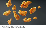 Grilled chicken legs, drumsticks falling in the air, isolated on black background, food concept. Crispy fried chicken nuggets levitation. Roast chicken strips, pieces flying in the air. Dynamic scene. Стоковое AI-видео, аниматор Марина Демидюк / Фотобанк Лори