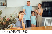 Angry man screaming at confused wife at home kitchen while two teenage daughters upset over parents arguing sitting at table with sad expressions. Concept of family conflicts. Стоковое видео, видеограф Яков Филимонов / Фотобанк Лори