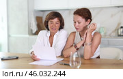 Women are sitting at table with papers and are immensely happy. Стоковое видео, видеограф Яков Филимонов / Фотобанк Лори