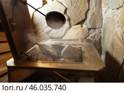 Close-up Hot stones in furnace for produce steam and heat in steam room. Steam an water on the stones, spa and wellness concept, relax in hot finnish sauna. Interior of wooden sauna. Стоковое фото, фотограф Сергей Тимофеев / Фотобанк Лори