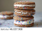 Stack of delicious whoopie pies with colorful sprinkles adding festive touch. Стоковое AI-изображение, AI-художник Иван Рябоконь / Фотобанк Лори