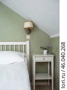 A bed with white sheets and a vintage Provence-style bedside table in a hotel room or a home bedroom. Space for the text. Enjoying the morning concept. Стоковое фото, фотограф Photojuli / Фотобанк Лори