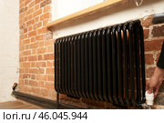 Modern radiator for heating in an apartment with power regulators. It is ideal for those expenses for heating and utilities in winter, when the heat level is regulated by humans. Стоковое фото, фотограф Darya Komarova / Фотобанк Лори