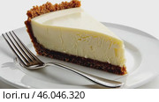 Delicious Slice of Creamy Cheesecake Delightfully Presented on a Plate. Sweet dessert. Close-up. Indulge in a tempting slice of rich cheesecake, featuring a delightful and crumbly graham cracker crust. Стоковое AI-видео, аниматор Марина Демидюк / Фотобанк Лори