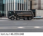 MAN TGS 41.470 tipper truck is driving in city on high speed. Dump truck MAN with bllack cabin at the city highway in motion. Редакционное фото, фотограф Константин Григорьев / Фотобанк Лори