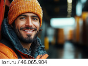 Smiling Latin American delivery driver stands at gate of an industrial warehouse. Стоковое AI-изображение, AI-художник Владимир Григорьев / Фотобанк Лори